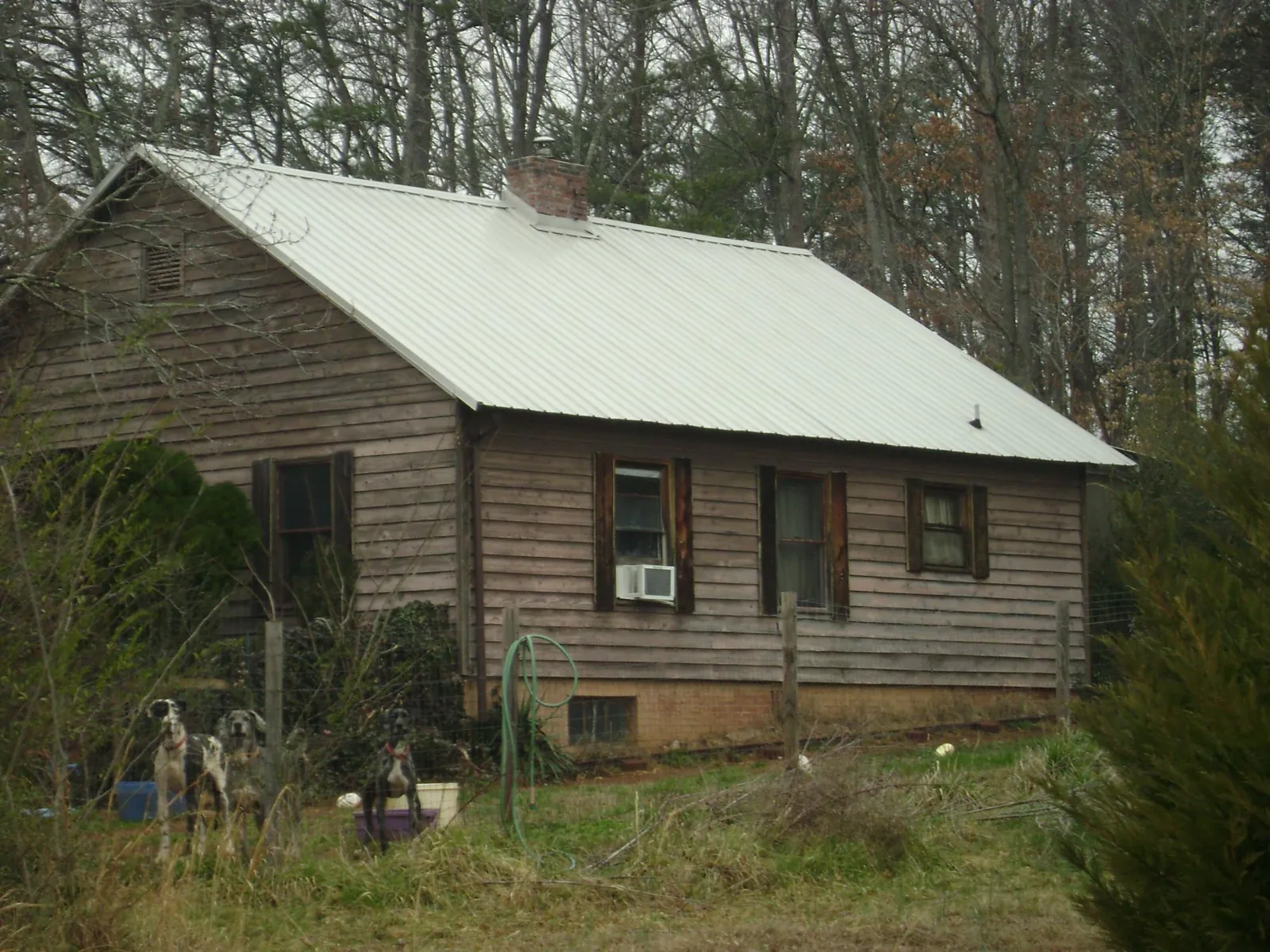 White metal roof on an old wood sided farmhouse, from a Metal Roof Installation job in Vian